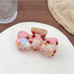 Beau hair claw clip with a glossy finish and gold-tone spring detail