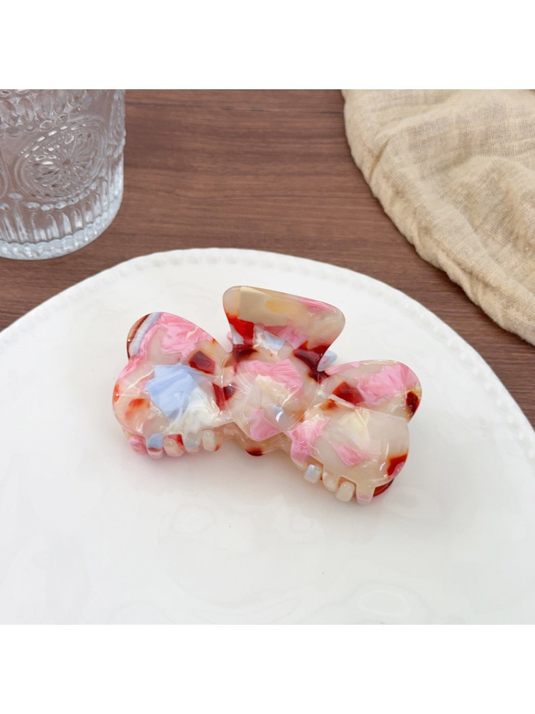 Beau hair claw clip with a glossy finish and gold-tone spring detail