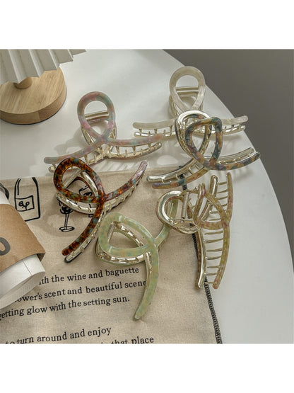 Close-up of Beau large acetate claw clip showing curved teeth and glossy finish