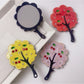 Mirroray handheld mirror with a stylish tree-shaped frame on a white background