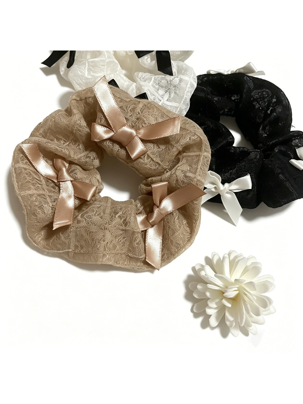 Gifty lace scrunchie with satin bow displayed on a white background