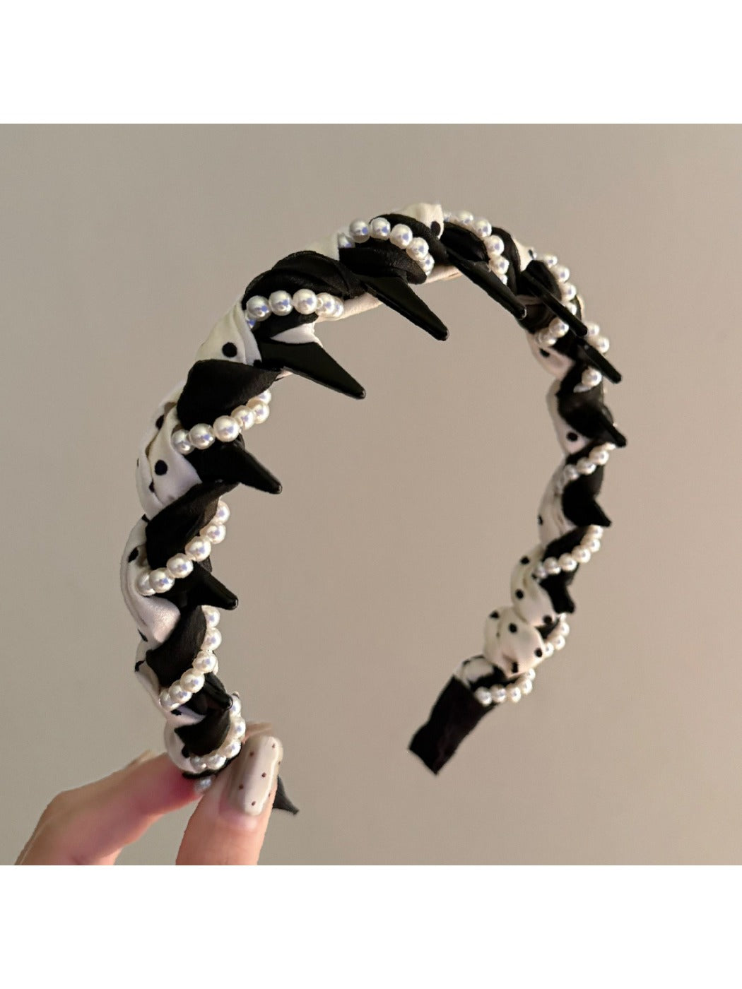 Close-up of black and white braided headband showing texture and pattern