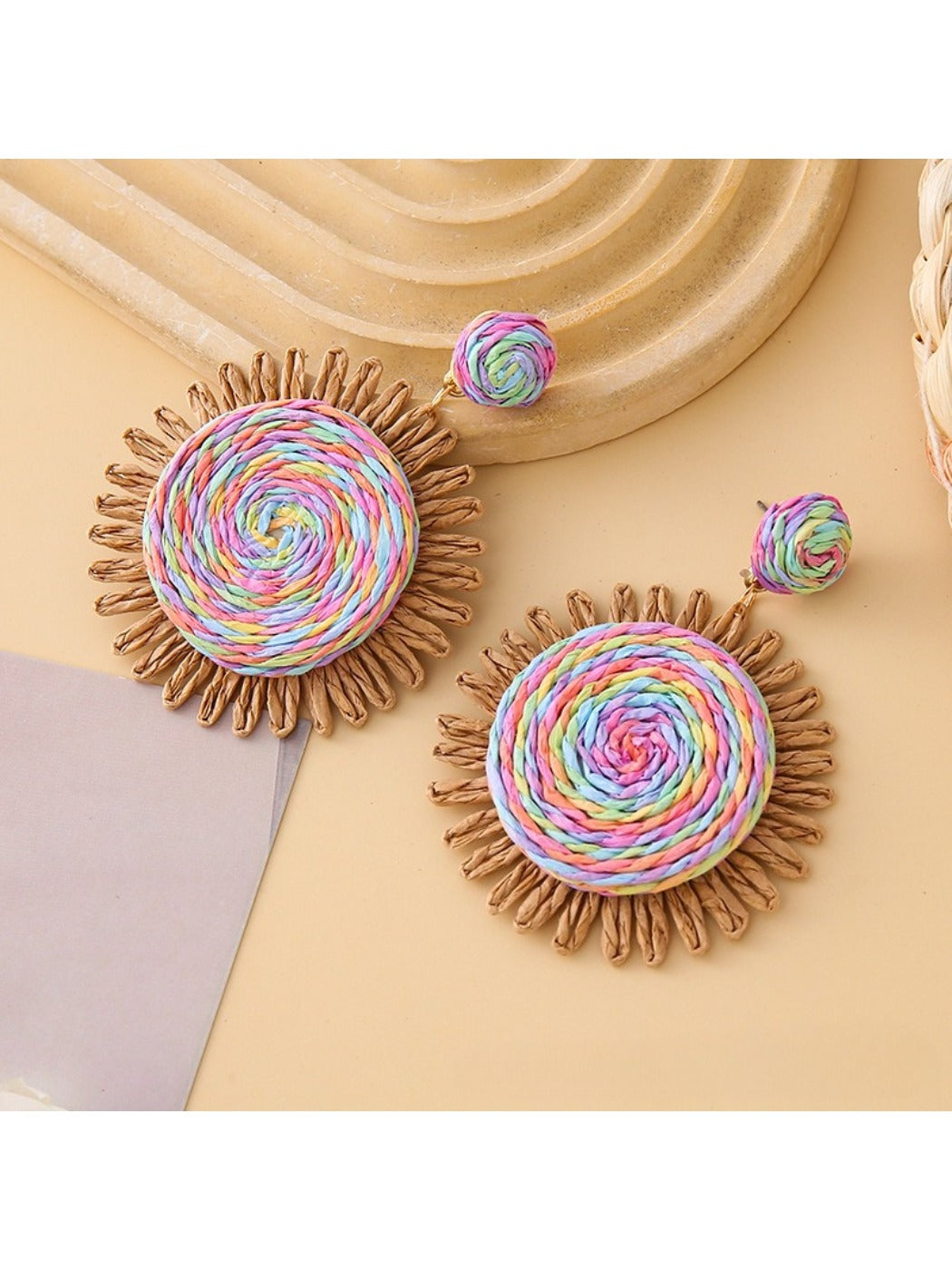 Side view of colorful raffia round earrings showing woven texture