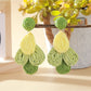 Top view of Earedge color block raffia drop earrings showing oval shape and woven details