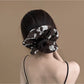 Gifty scrunchie displayed on a white background showing its textured fabric