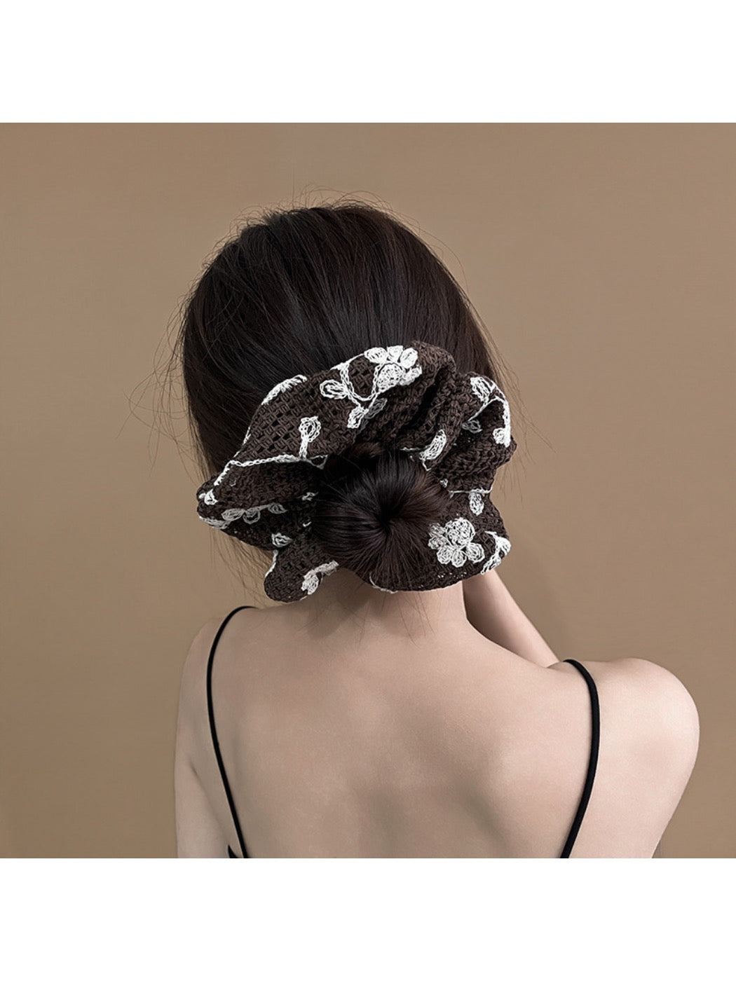 Gifty scrunchie displayed on a white background showing its textured fabric
