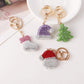 Pink stocking, purple hat, green tree and red Santa face keychains