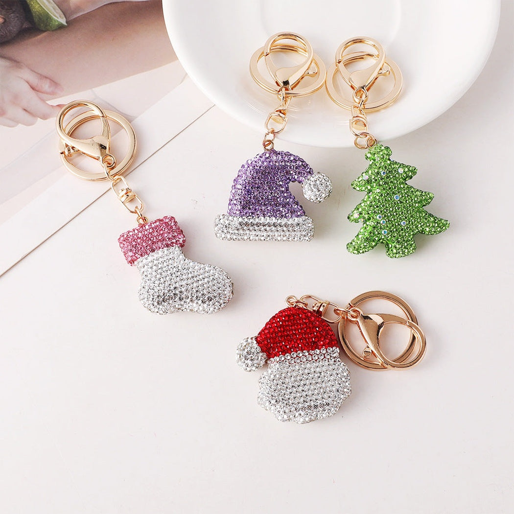 Pink stocking, purple hat, green tree and red Santa face keychains