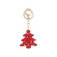 Red Christmas tree keychain on white background