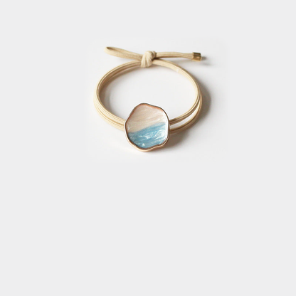 Khaki Gifty - Glazed Bead Hair Tie on neutral background