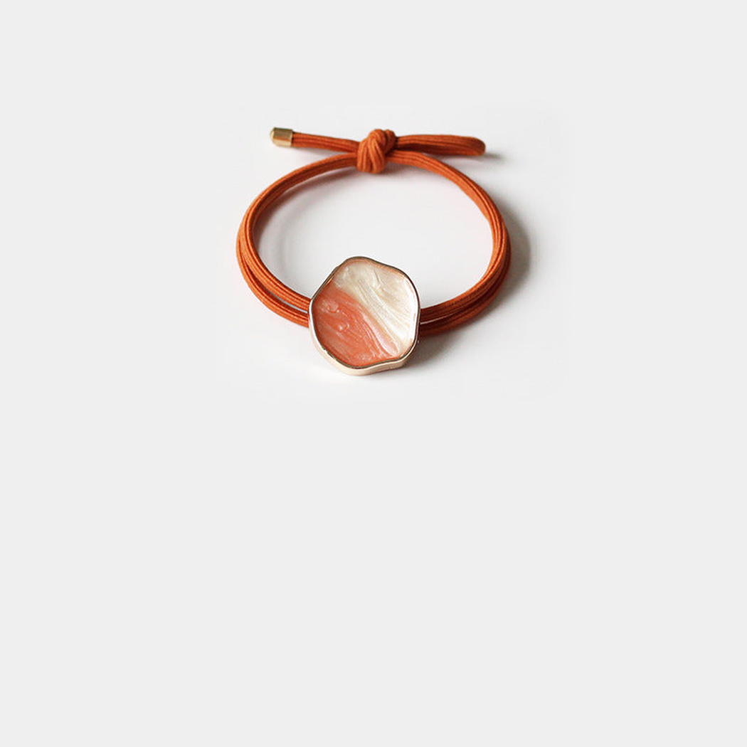 Orange Gifty - Glazed Bead Hair Tie on neutral background