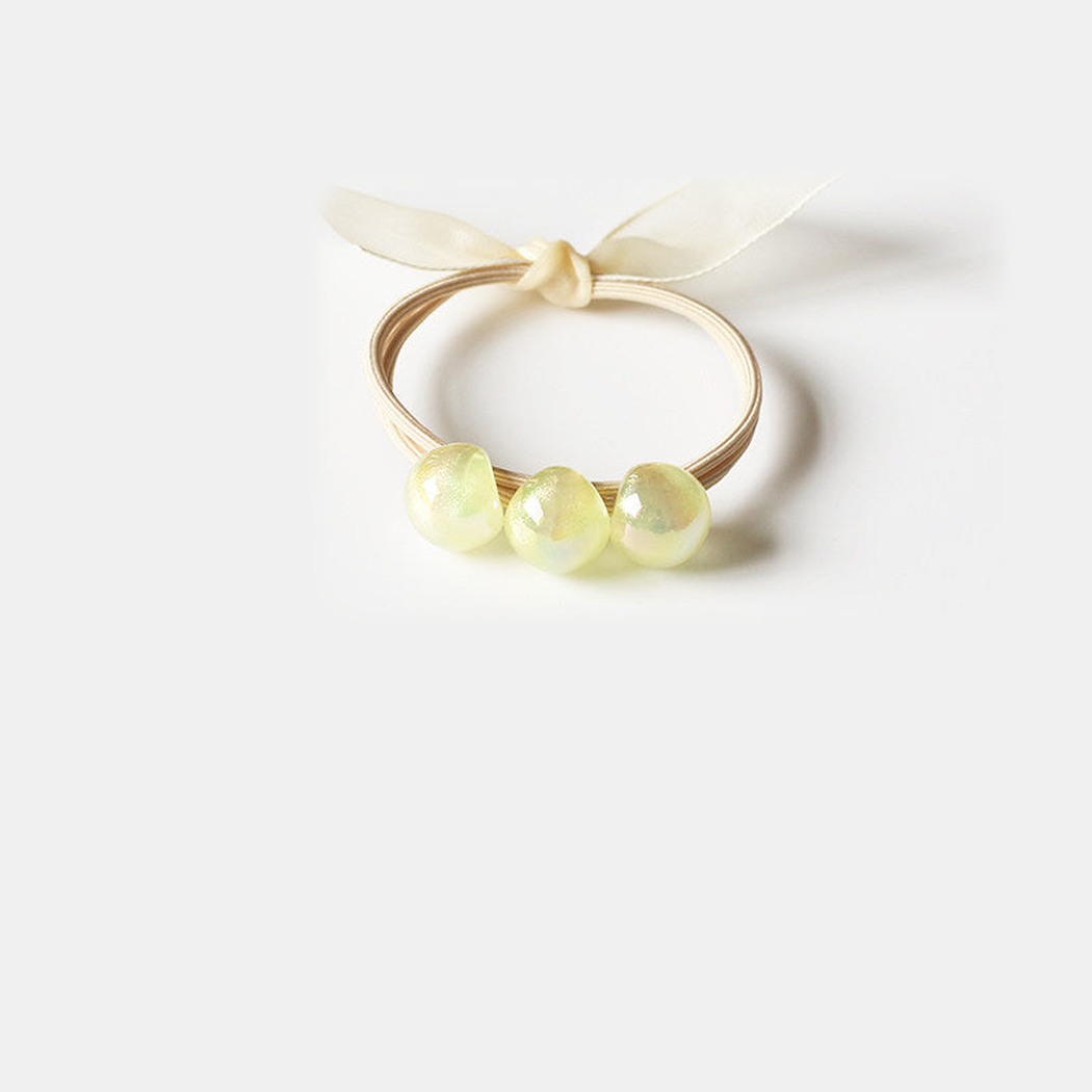 Yellow Gifty - Iridescent Bead Hair Tie on neutral background