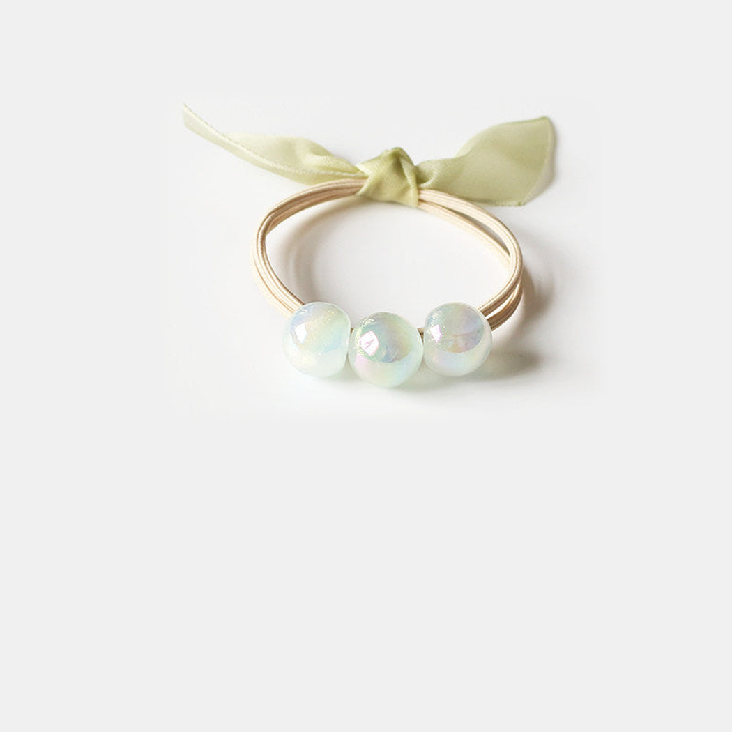 Green Gifty - Iridescent Bead Hair Tie on neutral background