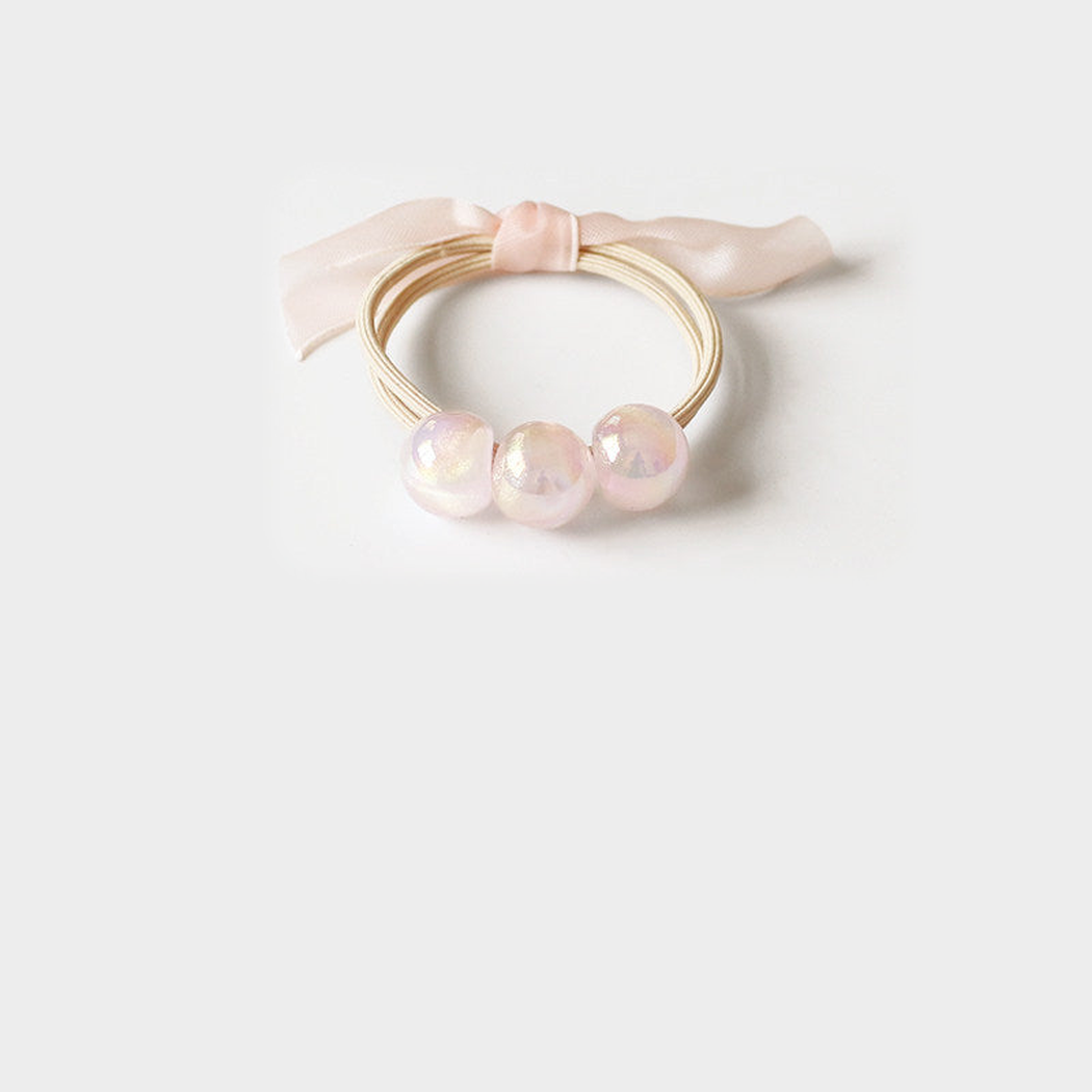 Pink Gifty - Iridescent Bead Hair Tie on neutral background