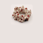 White Gifty - Gathered Floral Scrunchie on neutral background