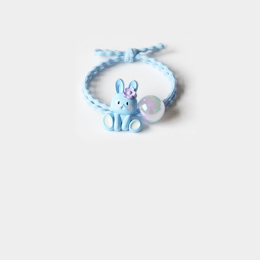 Blue Gifty - Bunny Charm Hair Tie on neutral background
