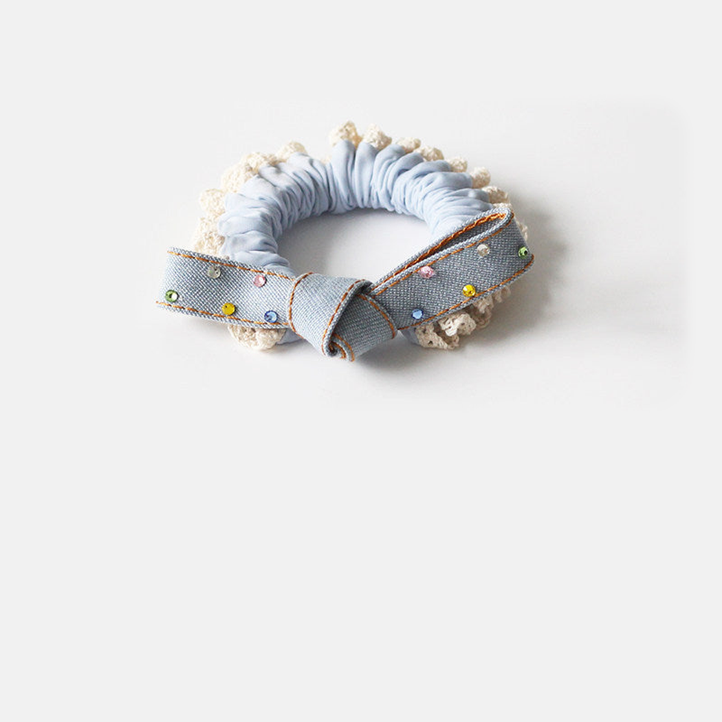 KnotBlue Gifty - Blue Bow Crystal Hair Tie on neutral background