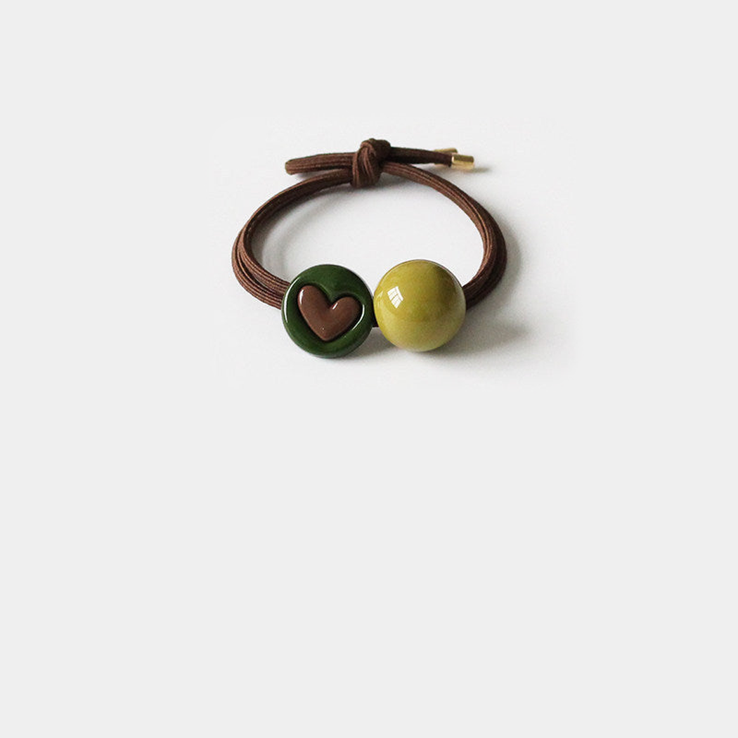 Heart Gifty - Green Charm Hair Tie on neutral background