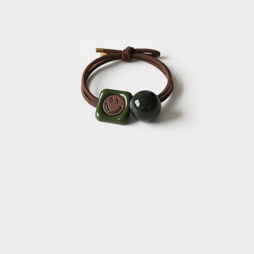 Smiley Gifty - Green Charm Hair Tie on neutral background