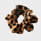 LeoDkBrown Gifty - Leopard Glossy Scrunchie on neutral background