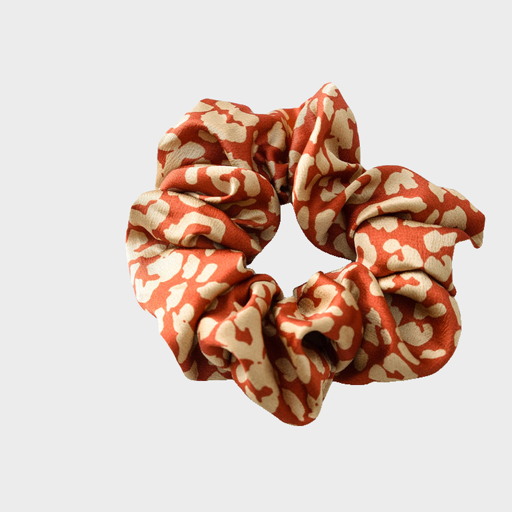 LeoBurg Gifty - Leopard Glossy Scrunchie on neutral background