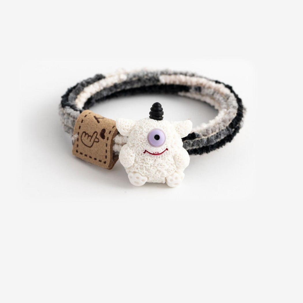 MonsBlkWht Gifty - Monster Label Hair Tie on neutral background