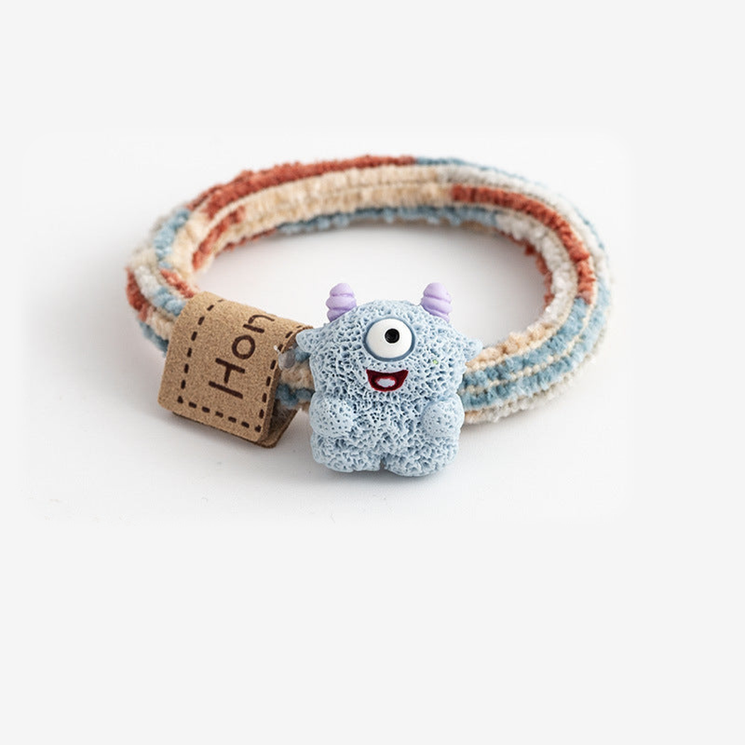 MonsBlue Gifty - Monster Label Hair Tie on neutral background