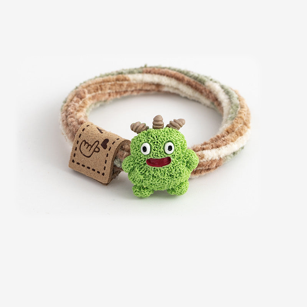 MonsGrn Gifty - Monster Label Hair Tie on neutral background