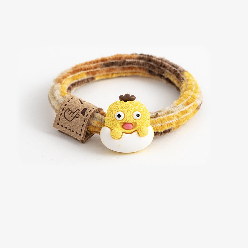 MonsYlw Gifty - Monster Label Hair Tie on neutral background