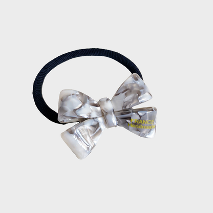 Gray Gifty - Iridescent Bow Hair Tie on neutral background