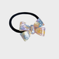 IridPurp Gifty - Iridescent Bow Hair Tie on neutral background