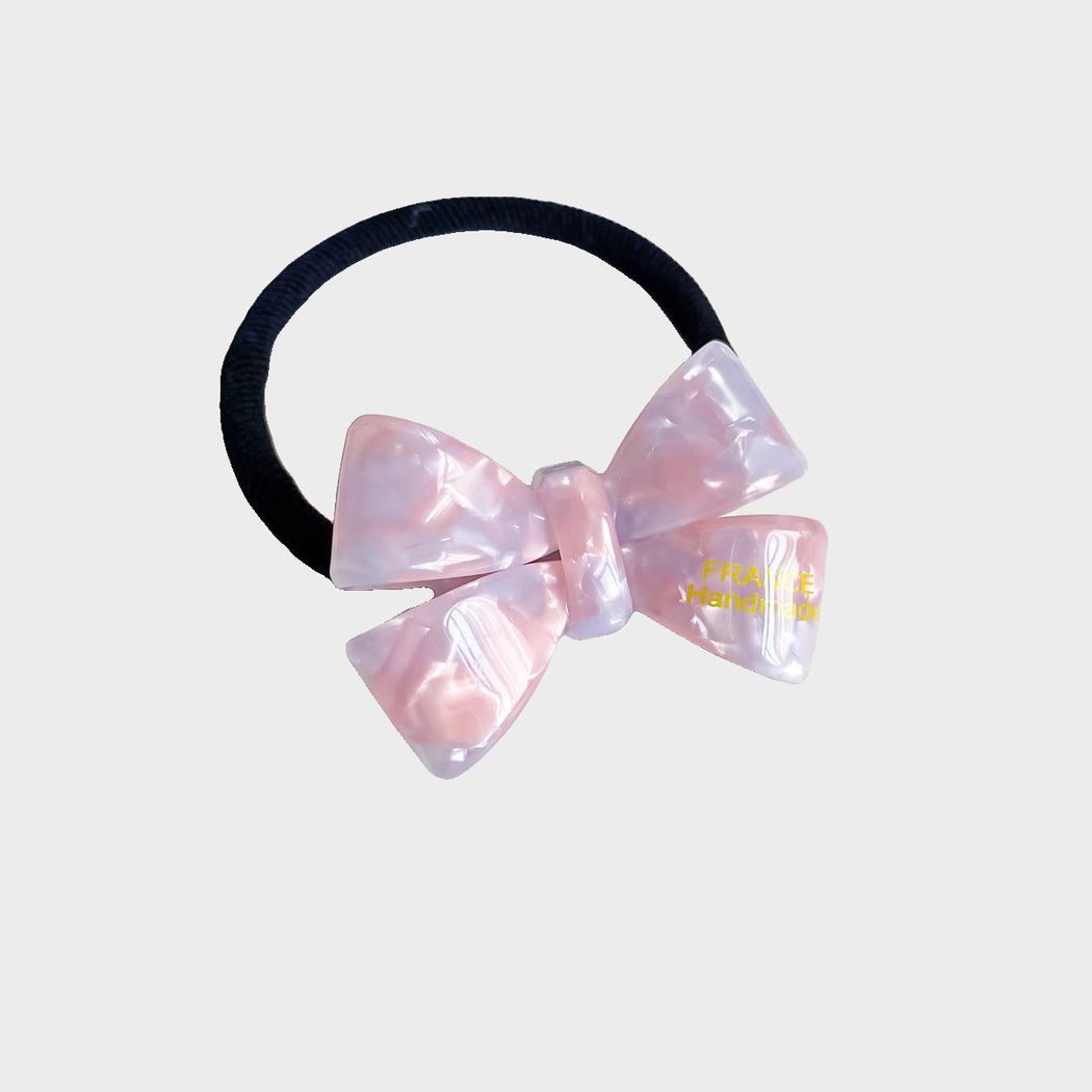 IridPnkPur Gifty - Iridescent Bow Hair Tie on neutral background