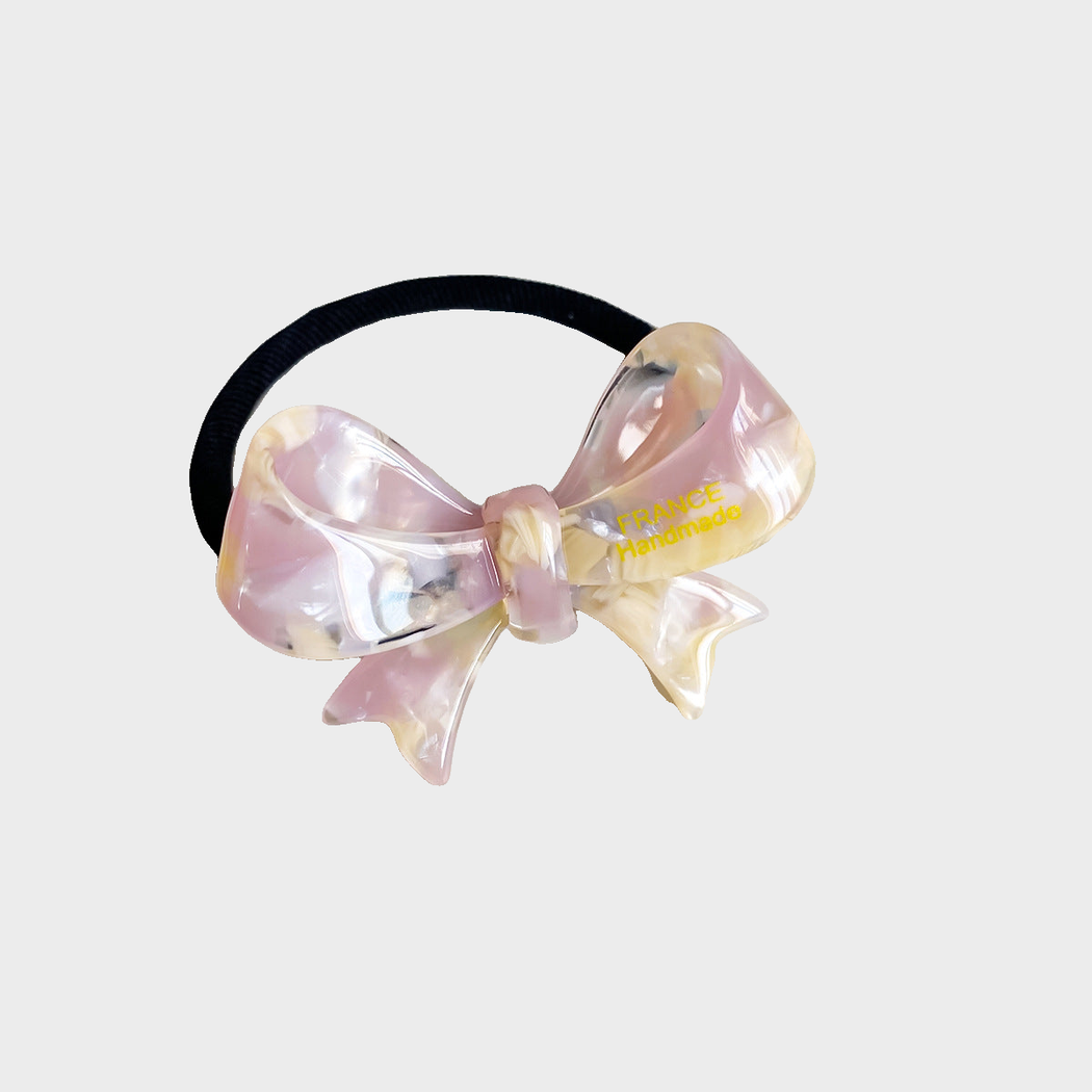 IridPnkYlw Gifty - Iridescent Bow Hair Tie on neutral background