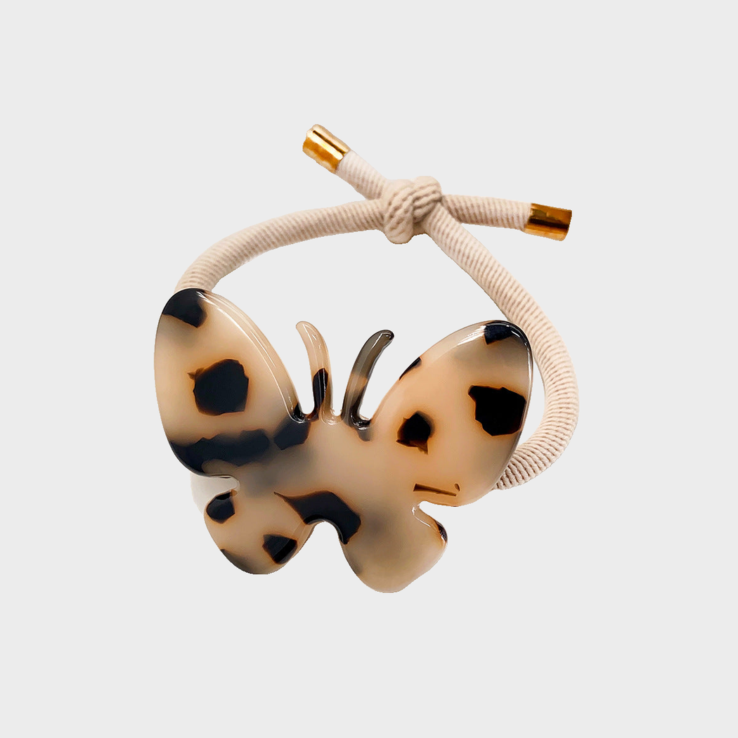 Tortoise Gifty - Butterfly Charm Hair Tie on neutral background
