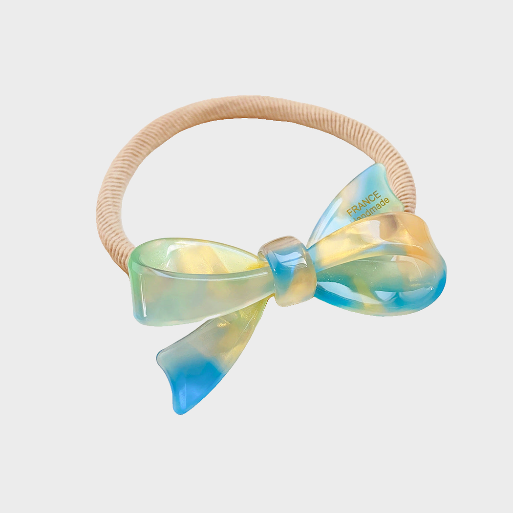 Iridescent Gifty - 3D Bow Hair Tie on neutral background