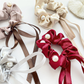 Beaded bow scrunchies in white, dusty rose, champagne, gray, and red