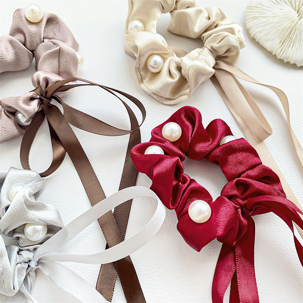 Beaded bow scrunchies in white, dusty rose, champagne, gray, and red