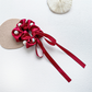 Red beaded bow scrunchie with trailing ribbons