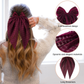 Wine dot-pattern trailing-bow hair clip worn from the back with detail insets